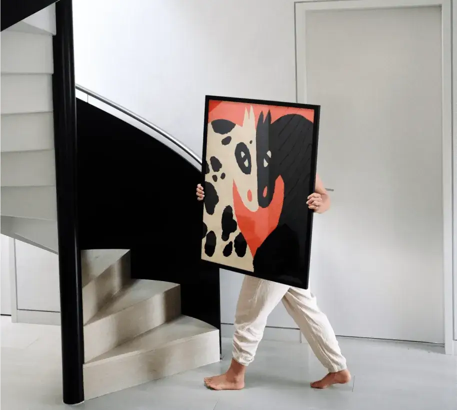 home interior with someone carrying some artwork